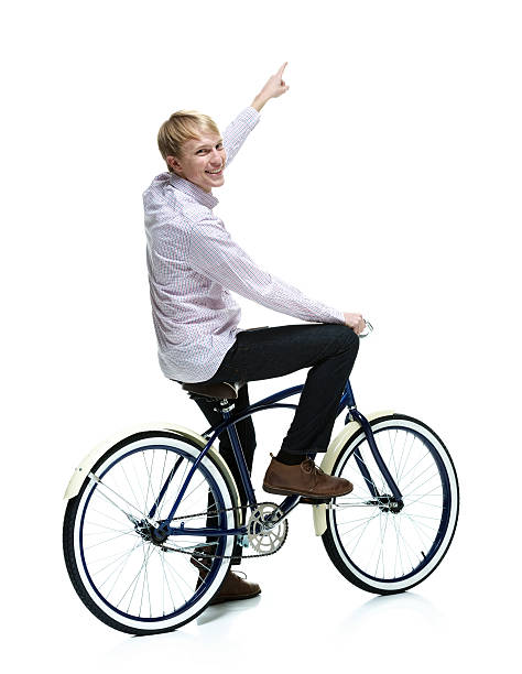 istock Smiling man sitting on bicycle and pointing 460507563