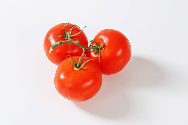 istock Ripe tomatoes isolated on white background 460510219