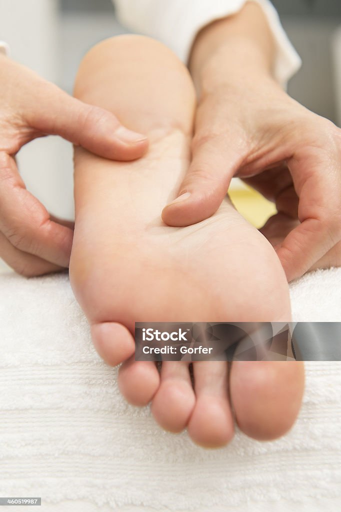 foot massage plantar reflexology in the salon by a trained specialist Adult Stock Photo