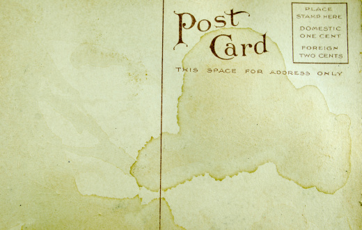 An old vintage post card... stained badly and with copy space.