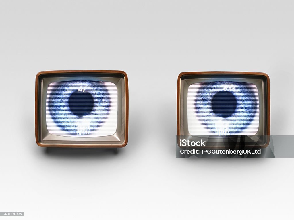 Two Television Sets With Eyes On Screens Digital composite of two television sets with eyes on screens Addiction Stock Photo