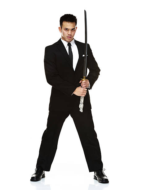 istock Man in suit holding a sword 460526139