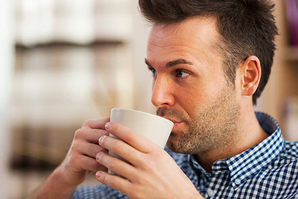 istock Close up man drinking coffee in home 460530527