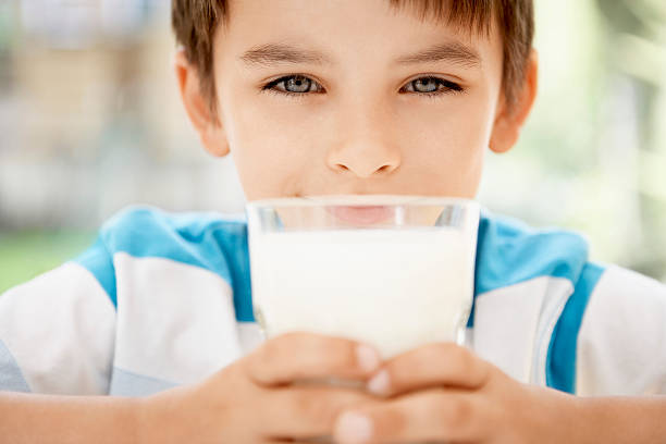 istock Boy Holding Glass Of Milk 460532773