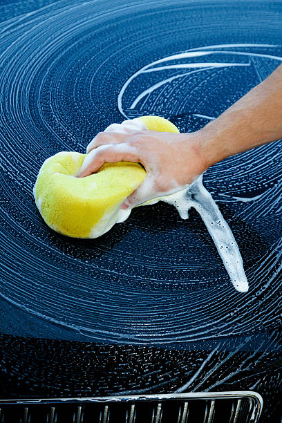 istock Black Car Wash with Yellow Sponge 460534523
