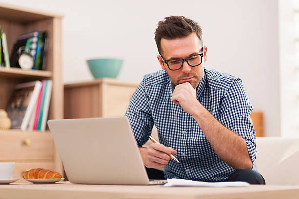 istock Busy man working at home 460536319