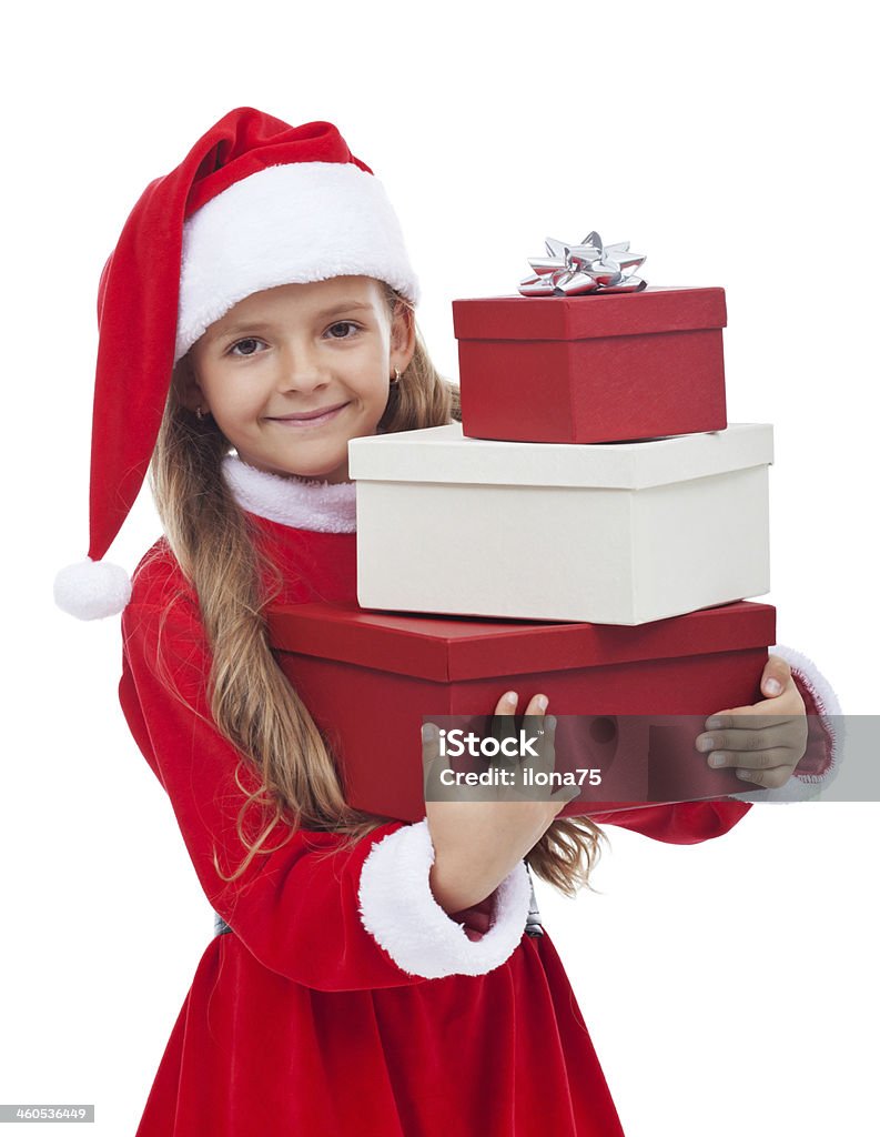 Girl in christmas outfit holding presents Girl in christmas outfit holding presents and smiling - isolated Beautiful People Stock Photo