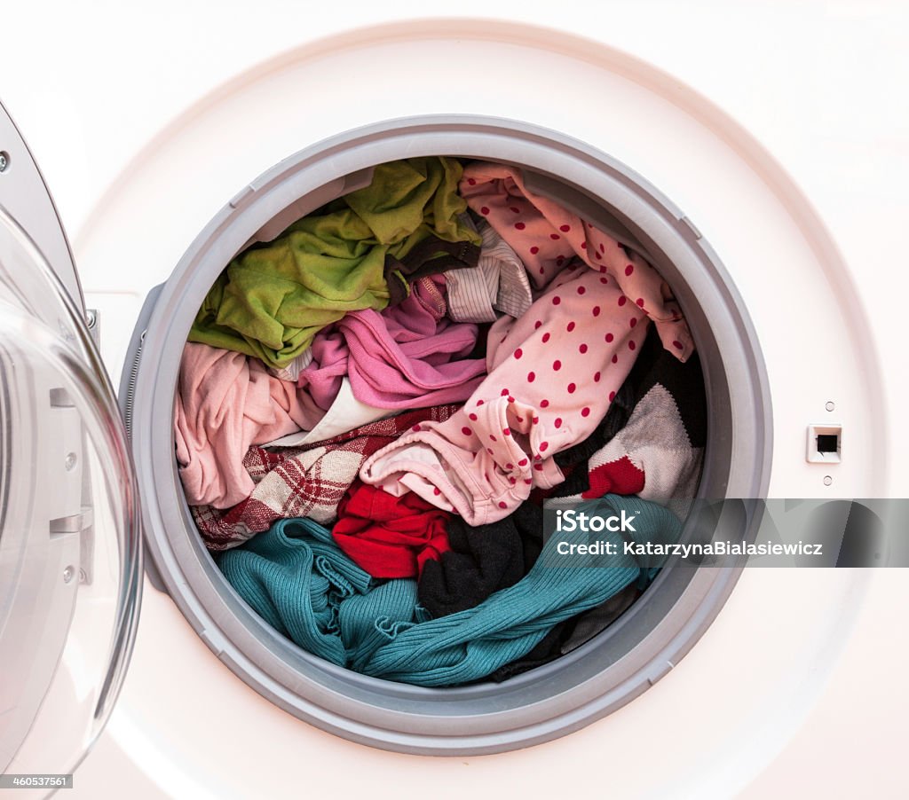 Laundry before washing Washing machine full of dirty clothes, closeup Washing Machine Stock Photo