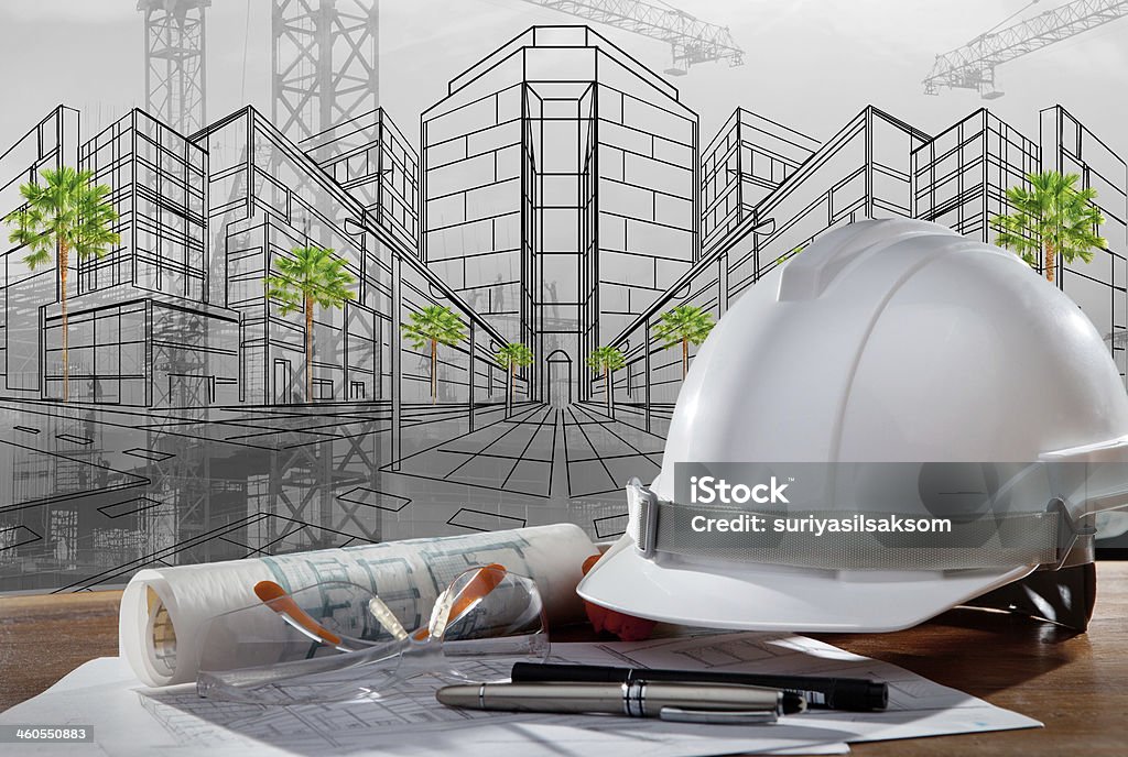 safety helmet and paper working plan of architecture safety helmet and paper working plan of architecture with building sketching  construction Civil Engineer Stock Photo