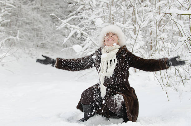 istock Young woman playing with snow 460553671