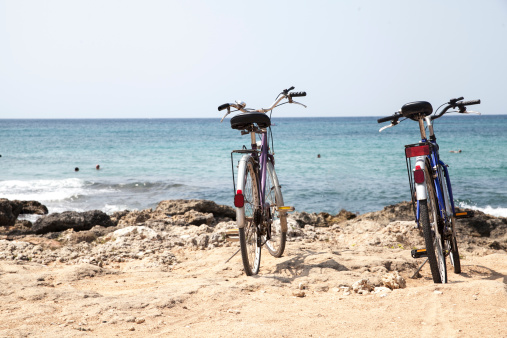 Two bicycles leave on the beach