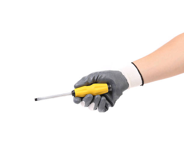 istock Hand in glove holding screwdriver. 460559221