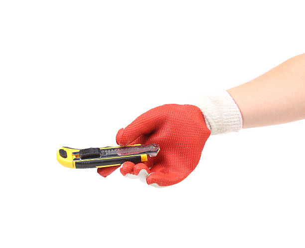istock Hand in glove holding knife. 460559235