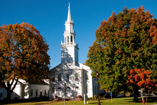 A classic white church and steeple in the autumn in Avon Connecticut.