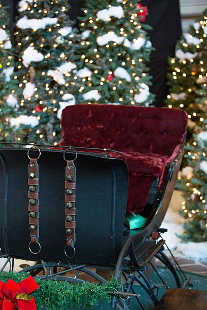 An old fashioned sleigh with sleigh bells and Christmas trees