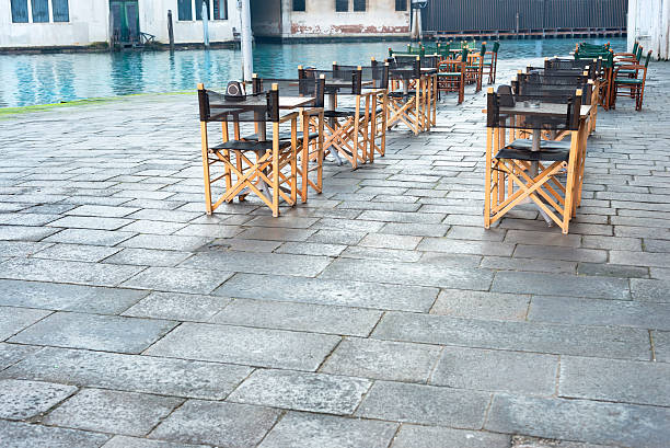 Chairs in the sunday morning waiting for people to come, Venice, Italy.