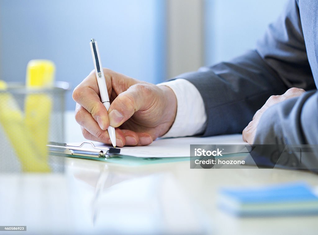 Businessman writing Businessman writing something. Adult Stock Photo