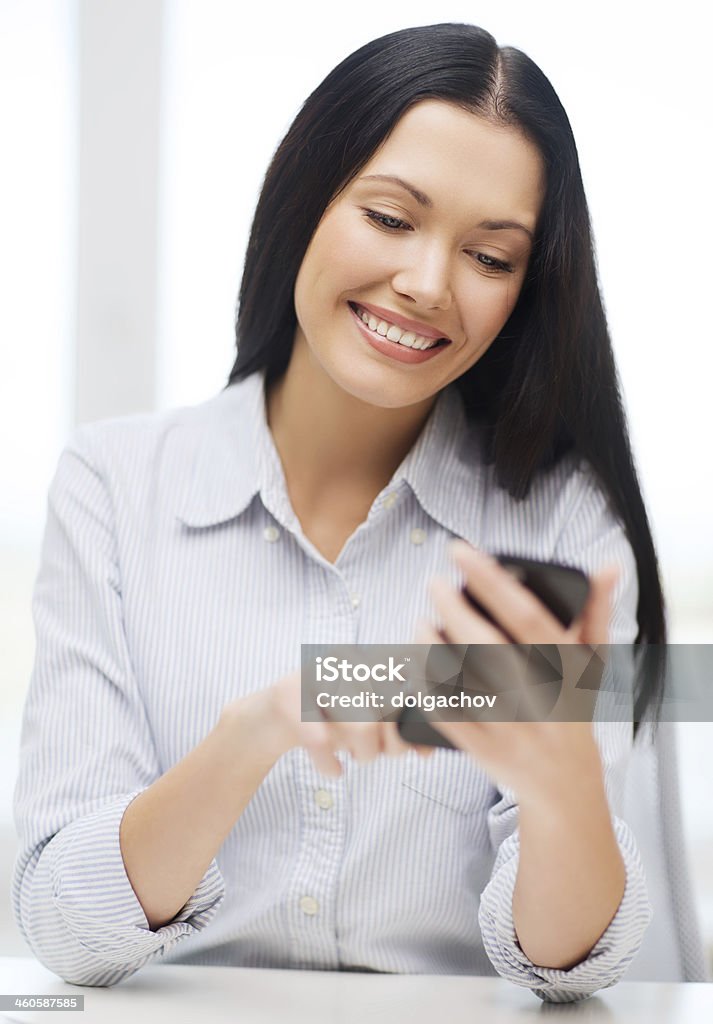 Business woman or student smiling while using a smartphone business, education, technology and internet concept - smiling businesswoman or student with smartphone Girls Stock Photo