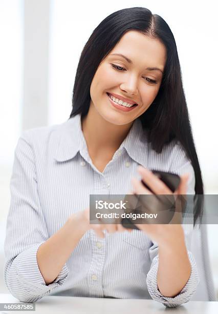 Business Woman Or Student Smiling While Using A Smartphone Stock Photo - Download Image Now