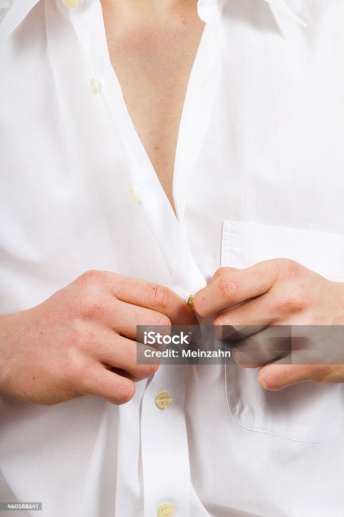 buttoning a fresh, white shirt buttoning a fresh, white shirt, on plain white background Adult Stock Photo