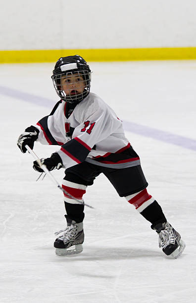 istock A child on the ice in his hockey uniform 460592427