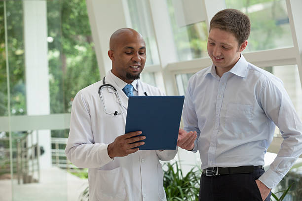 istock Doctor and patient discussing medical record 460593267
