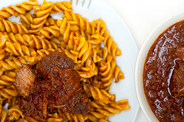 fusilli pasta al dente with neapolitan style ragu meat sauce very different from bolognese style