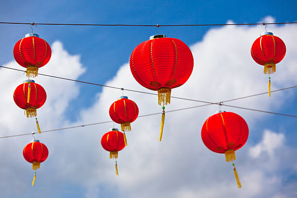 istock Red Chinese Paper Lanterns against a Blue Sky 460599681