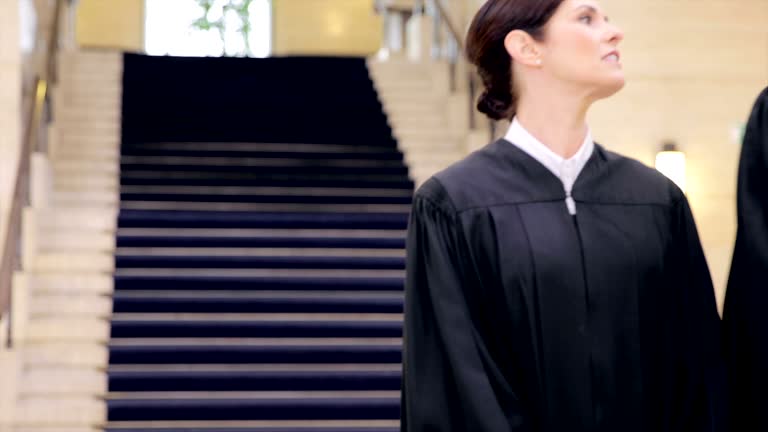 Judges and lawyers walking in courthouse