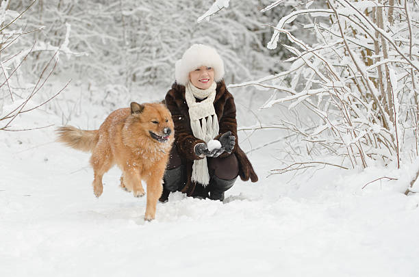 istock Young woman playing with dog 460635033