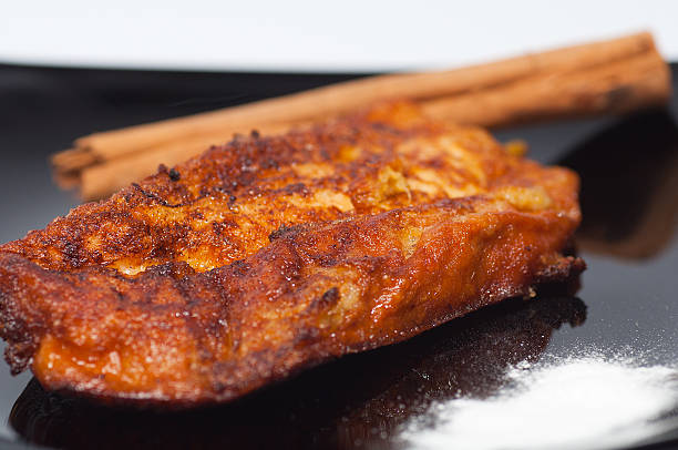 Torrija on a black plate. stock photo