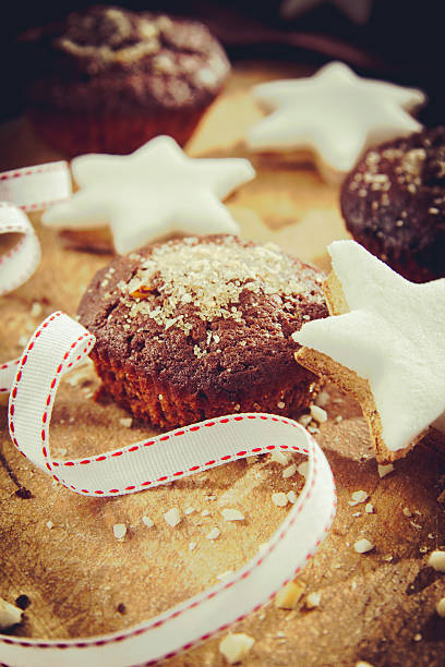 Chocolate muffins with sugar and star cookies stock photo