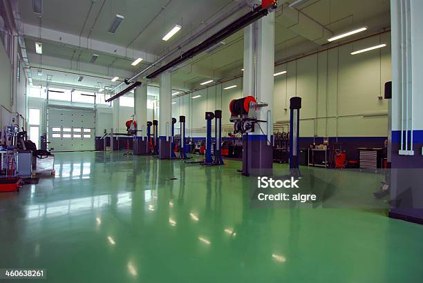 An Empty Repairs Garage With Green Floor Stock Photo - Download Image Now - Auto Repair Shop, Gas Station, Mechanic