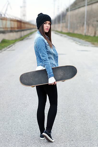 istock Woman holding skateboard 460638483