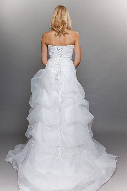 istock blonde bride white long wedding dress back view on gray 460642113