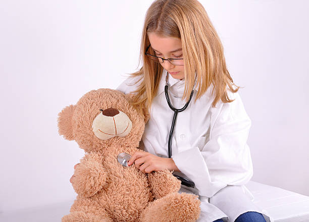 istock Girl-doctor treated his teddy bear 460654941