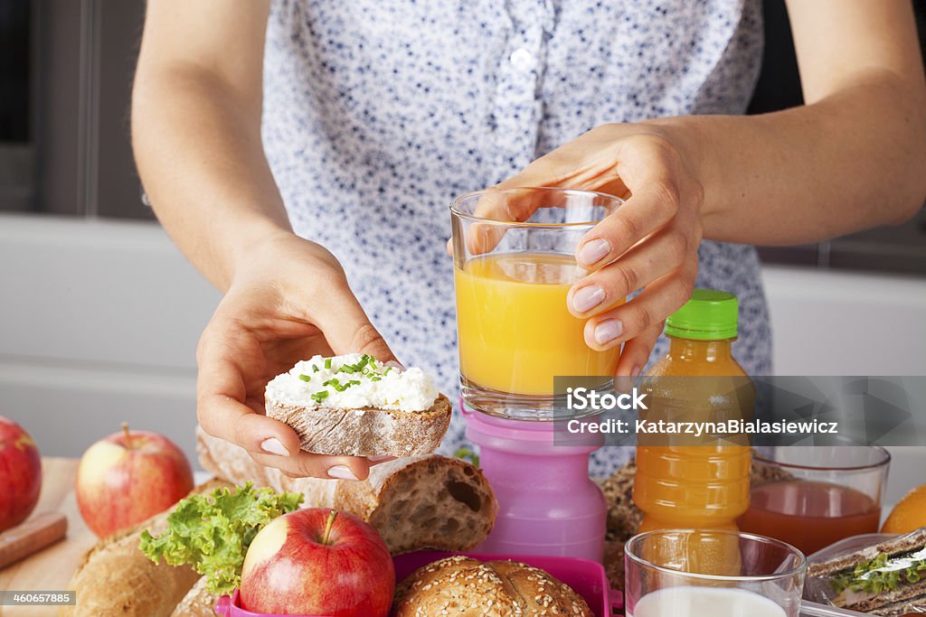 Woman with tasty sandwich and juice Woman giving tasty sandwich with brie and orange juice Adult Stock Photo