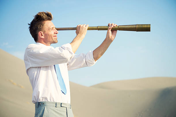 istock Searching Businessman Holding Telescope Desert Landscape 460670961