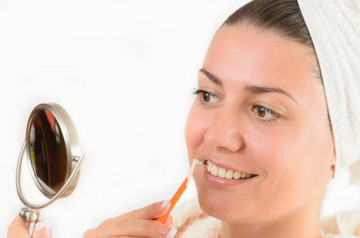 Young woman using an interdental brush