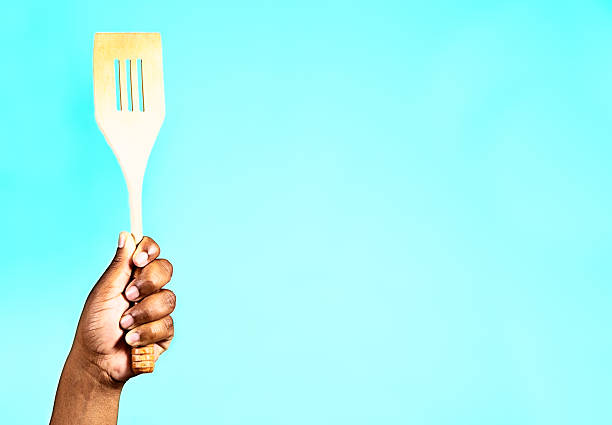 istock Cook's hand with multi-purpose kitchen tool of the trade 460711849