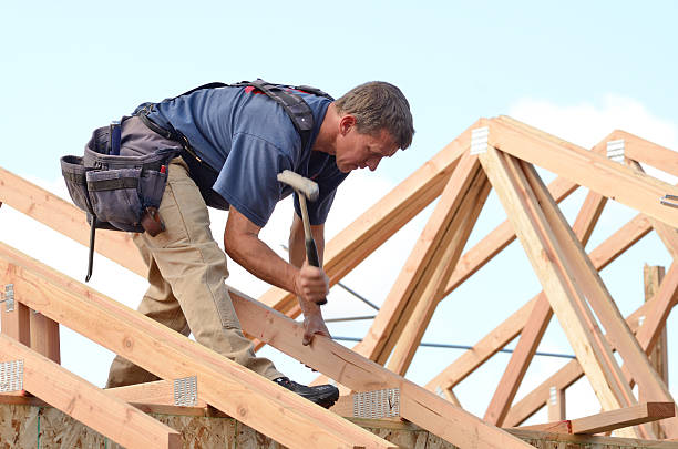 istock A person on a roof rafter using a hammer 460728143