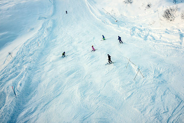 People skiing in Alagna, Monte Rosa, Italy Alagna, Italy - December 27, 2013: A group of six people skiing down a slope in Alagna, on the Monte Rosa mountain, Italian side. roberto alagna stock pictures, royalty-free photos & images