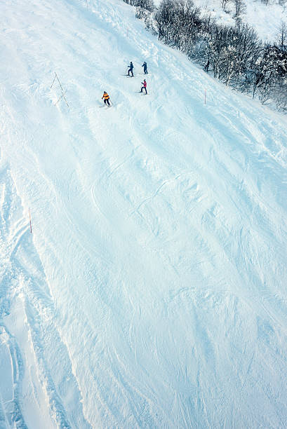 People skiing in Alagna, Monte Rosa, Italy Alagna, Italy - December 27, 2013: A group of four people skiing down a slope in Alagna, on the Monte Rosa mountain, Italian side. roberto alagna stock pictures, royalty-free photos & images
