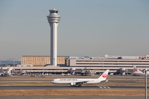 Tokyo, Japan - December 24, 2013: Japan Airlines airplanes at Tokyo International Airport (Haneda Airport) in Japan. It is located in Ota Ward, Tokyo, Japan. Tokyo International Airport is the busiest airport in Japan.