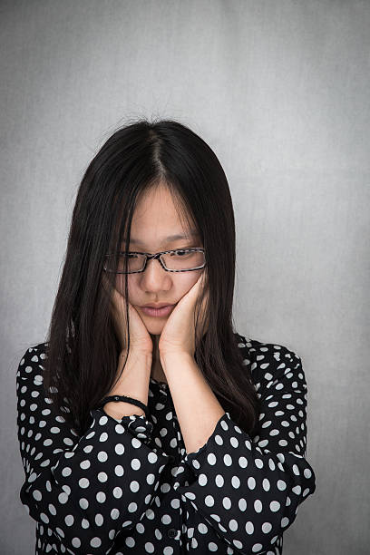 istock Depressed girl holding her face 460742971