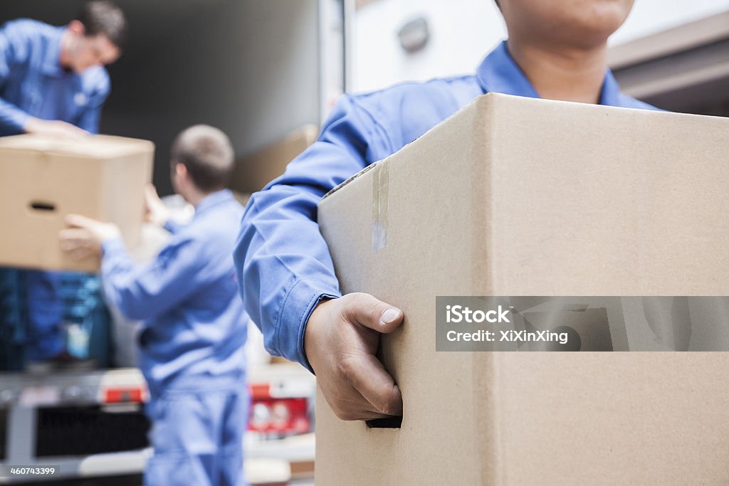 Movers unloading a moving van Relocation Stock Photo