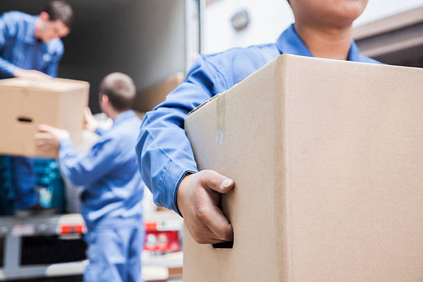 Movers unloading a moving van stock photo