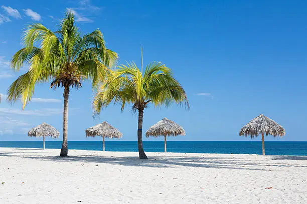 Caribbean beach with parasol in Cuba, Playa Ancon Trinidad