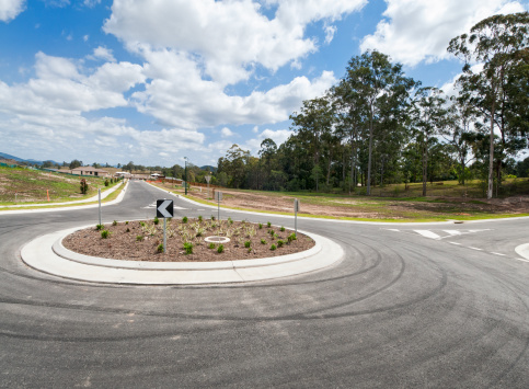 A small roundabout on a road through a housing development in Australia.