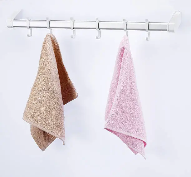 Hanging towels front white background.